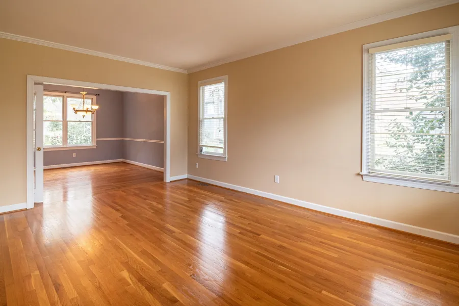 Wide plank hardwood floor in an empty, bright room